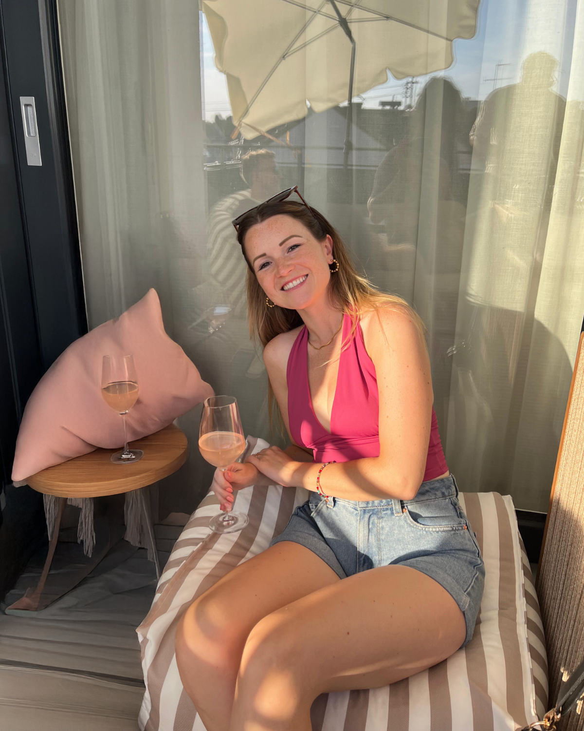 Mel with a glass of wine on a hotel terrace